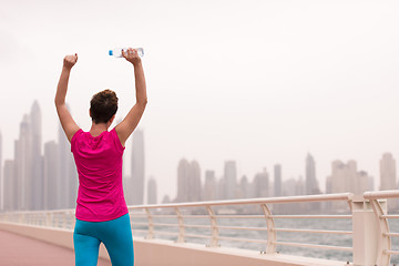 Image showing young woman celebrating a successful training run