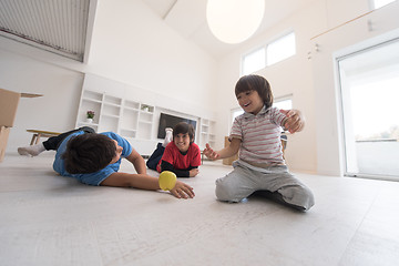 Image showing boys having fun with an apple on the floor