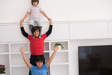 Image showing young boys posing line up piggyback