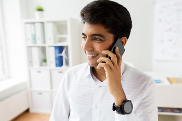 Image showing businessman calling on smartphone at office