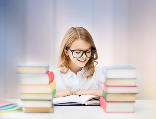 Image showing happy smiling student girl reading book