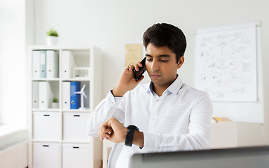 Image showing businessman calling on smartphone at office