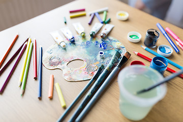 Image showing color palette, brushes and paint tubes on table