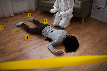 Image showing criminalist collecting evidence at crime scene