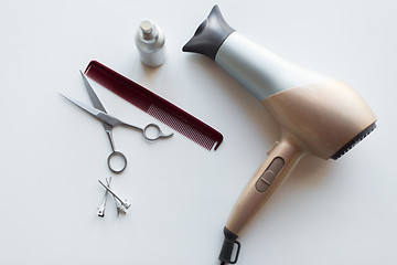 Image showing hairdryer, scissors, comb and styling hair spray
