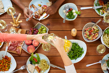 Image showing people at table with food eating and drinking