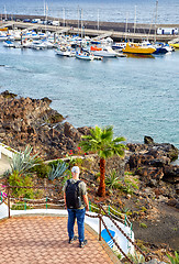 Image showing Tourist man enjoying panoramic view of Puerto del Carmen town 