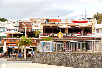 Image showing Tourists are sitting and eating in restaurants of the Puerto del