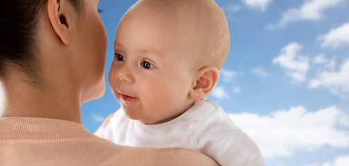 Image showing close up of happy little baby with mother over sky