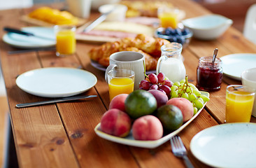 Image showing fruits, juice and other food on table at breakfast