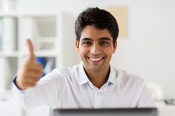 Image showing businessman showing thumbs up at office