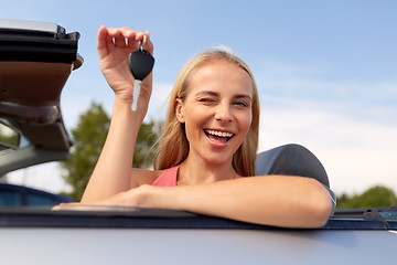 Image showing happy young woman with convertible car key