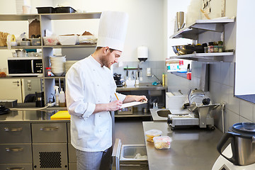 Image showing chef with clipboard doing inventory at kitchen