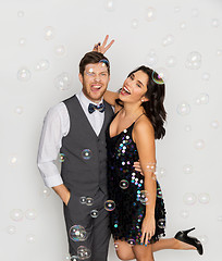 Image showing happy couple hugging in soap bubbles at party