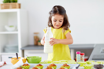 Image showing little girl baking muffins at home