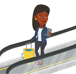 Image showing Woman using smartphone on escalator in airport.