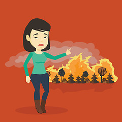 Image showing Woman standing on the background of wildfire.