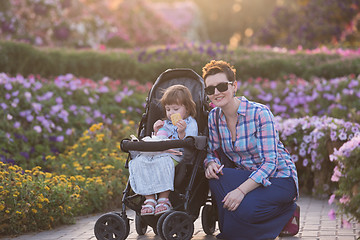 Image showing mother and daughter in flower garden