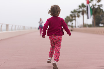 Image showing mother and cute little girl on the promenade by the sea