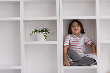 Image showing young boy posing on a shelf