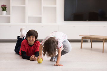 Image showing boys having fun with an apple on the floor