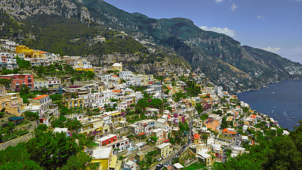 Image showing One of the best resorts of Italy with old colorful villas on the steep slope, nice beach, numerous yachts and boats in harbor and medieval towers along the coast, Positano.