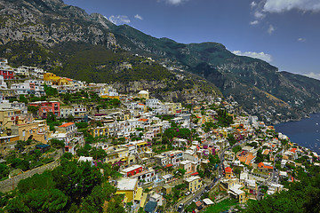 Image showing One of the best resorts of Italy with old colorful villas on the steep slope, nice beach, numerous yachts and boats in harbor and medieval towers along the coast, Positano.