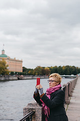 Image showing Woman taking shots on waterfront