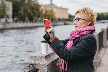 Image showing Woman taking shots on waterfront