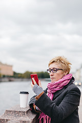 Image showing Woman with phone on esplanade