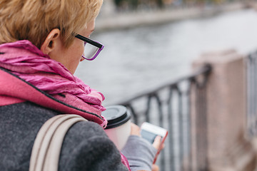 Image showing Woman using smartphone at river