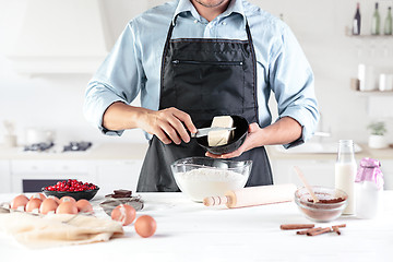 Image showing A cook with eggs on a rustic kitchen against the background of men\'s hands