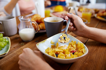 Image showing hands of woman eating cereals for breakfast