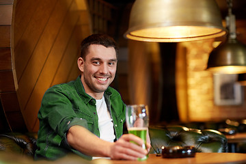 Image showing man drinking green beer at bar or pub