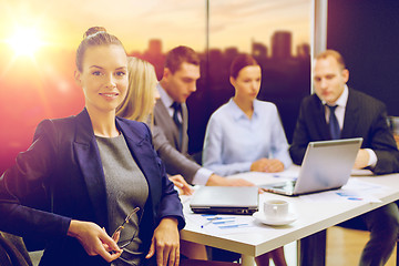 Image showing businesswoman and business team at office