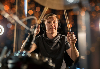 Image showing male musician playing drum kit at concert