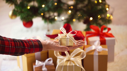 Image showing close up of hand holding small christmas gift box