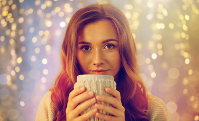 Image showing happy woman with cup of tea or coffee at home