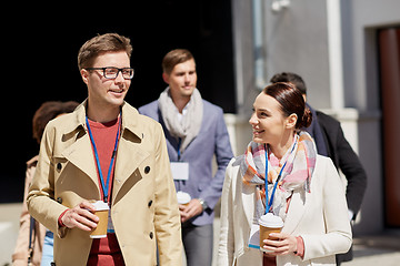 Image showing office workers with coffee on city street