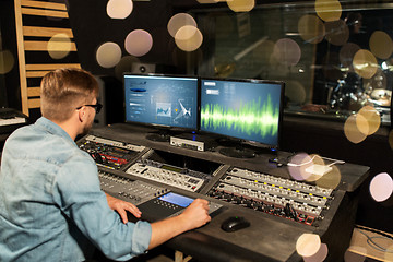 Image showing man at mixing console in music recording studio