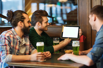 Image showing friends with tablet pc and green beer at pub