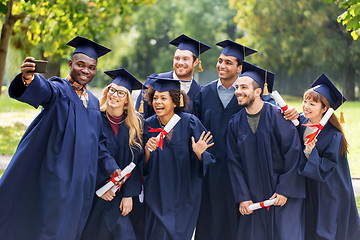 Image showing students or graduates with diplomas taking selfie