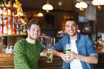 Image showing male friends drinking green beer at bar or pub