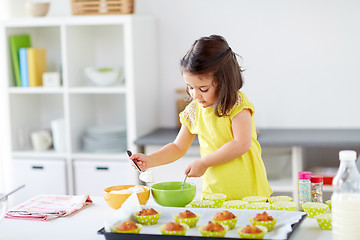 Image showing little girl baking muffins at home