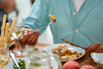 Image showing close up of man eating with fork and knife