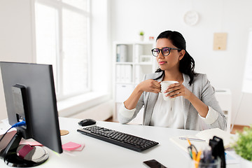 Image showing businesswoman drinking coffee or tea at office
