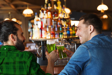 Image showing male friends drinking green beer at bar or pub