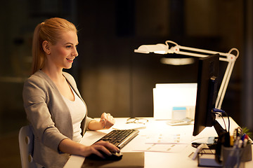 Image showing businesswoman at computer working at night office