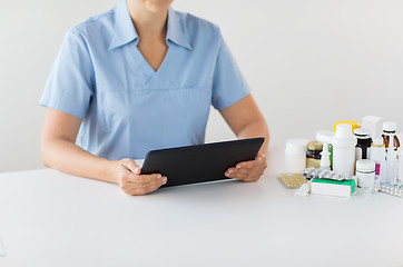 Image showing nurse or doctor with medicines and tablet pc