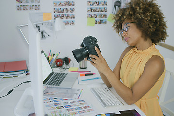 Image showing Young woman exploring photos on camera